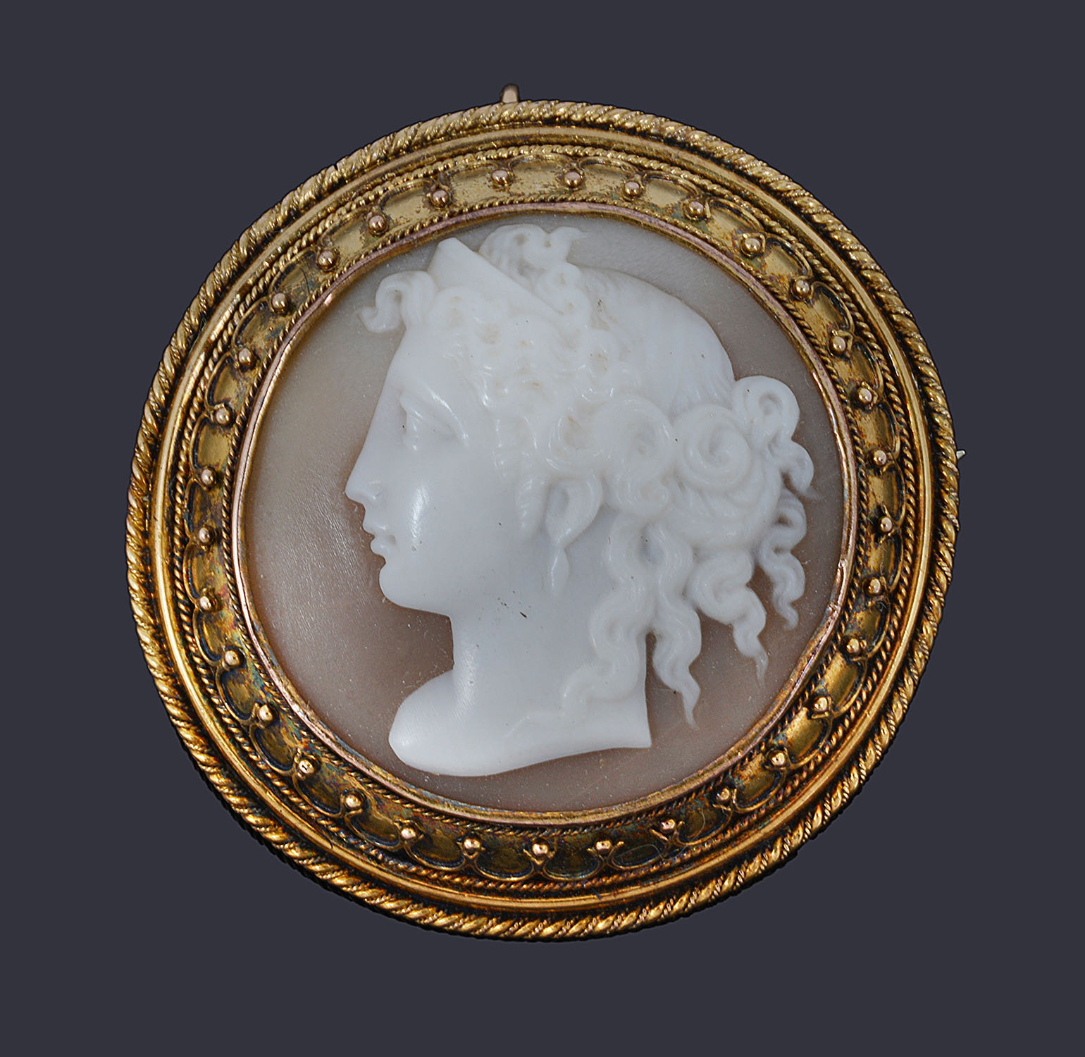 A Victorian Etruscan revival style circular shell cameo brooch