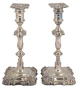 A pair of late Victorian George II style silver candlesticks