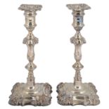 A pair of late Victorian George II style silver candlesticks