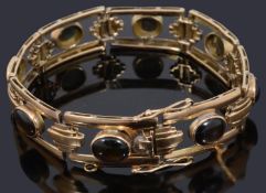 A gold open panel cabochon bracelet