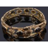 A gold open panel cabochon bracelet