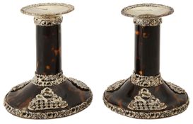 A pair of late Victorian silver mounted tortoiseshell dwarf candlesticks