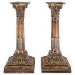 A pair of late Victorian silver stop fluted Corinthian column candlesticks