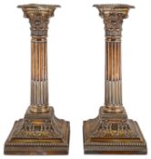 A pair of late Victorian silver stop fluted Corinthian column candlesticks