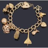 A 9ct gold hollow curb link bracelet suspended with padlock and ten assorted gold charms