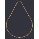 An Indian high carat gold single row bead necklace