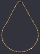 An Indian high carat gold single row bead necklace