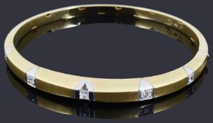 A two colour gold diamond hinged stiff bangle