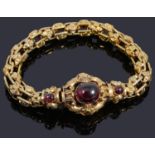 An attractive Victorian gold Etruscan revivial style garnet cabochon bracelet
