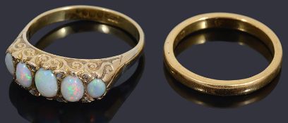 An opal set five stone half hoop ring and a wedding ring