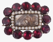 A Georgian flat cut garnet and seed pearl memorial brooch