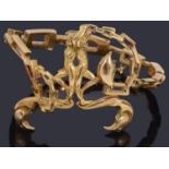An attractive gold abstract design hinged bangle