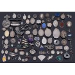 A large collection of silver brooches, pendants and lockets