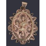 A gold African filigree pendant