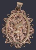 A gold African filigree pendant