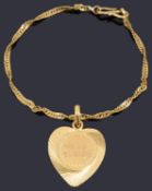 A high carat gold twisted curb link bracelet with a high carat gold heart shaped pendant