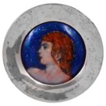 An Arts & Crafts enamel on copper portrait roundel in a circular silver frame