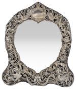 An Edwardian silver heart shaped ornate dressing table mirror