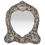 An Edwardian silver heart shaped ornate dressing table mirror