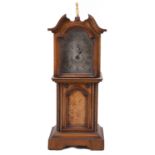 A late 19th century continental walnut miniature longcase mantle clock