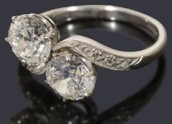 An attractive two stone diamond crossover 'toi et moi' ring