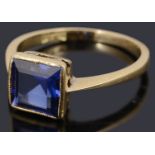 A delicate single stone square shaped step cut synthetic sapphire ring,