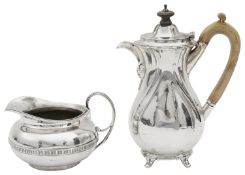 A George IV silver cream jug and an Edward VII hot milk jug or small coffee pot
