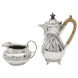 A George IV silver cream jug and an Edward VII hot milk jug or small coffee pot