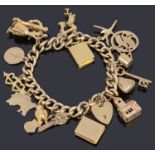 A 9ct gold hollow curb link bracelet with padlock and seventeen assorted gold charms