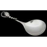 A Danish Sterling silver caddy or jam spoon by Georg Jensen in the blossom pattern
