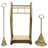 An Victorian brass and cast iron stick stand and two 19th century brass doorstops