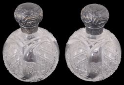 A pair of late Victorian silver mounted scent bottles