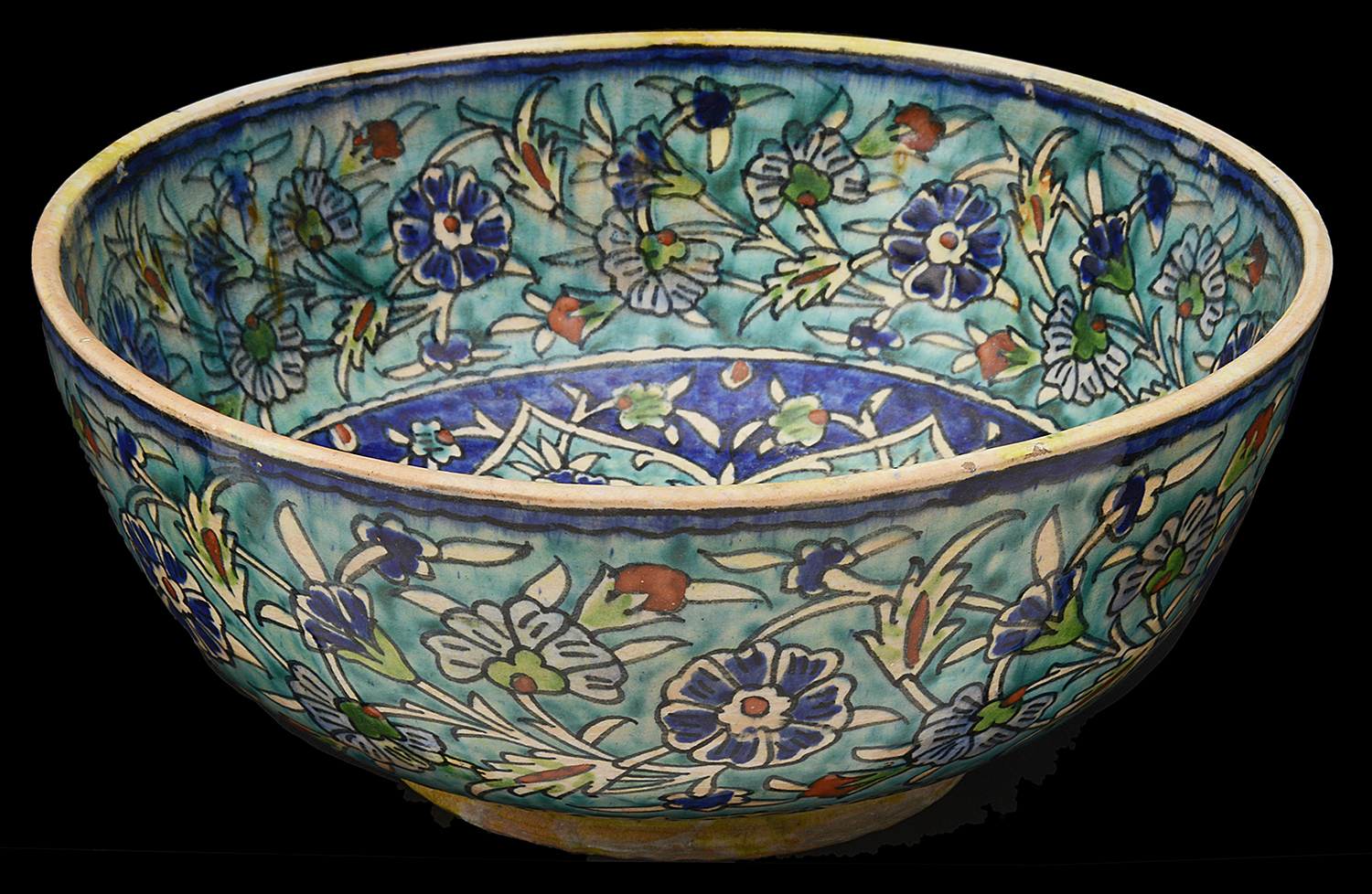 A large 19th century Iznik pottery polychrome tin glazed bowl