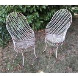 Two late 19th/early 20th century white painted wirework garden/ conservatory armchairs