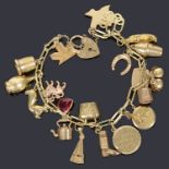 A charm bracelet mark 585 with padlock and assorted charms