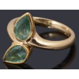An 18ct gold two stone emerald crossover ring,
