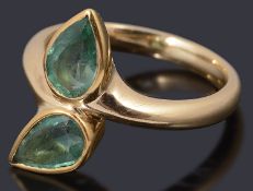 An 18ct gold two stone emerald crossover ring,