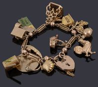 A gold charm bracelet with padlock and various gold charms