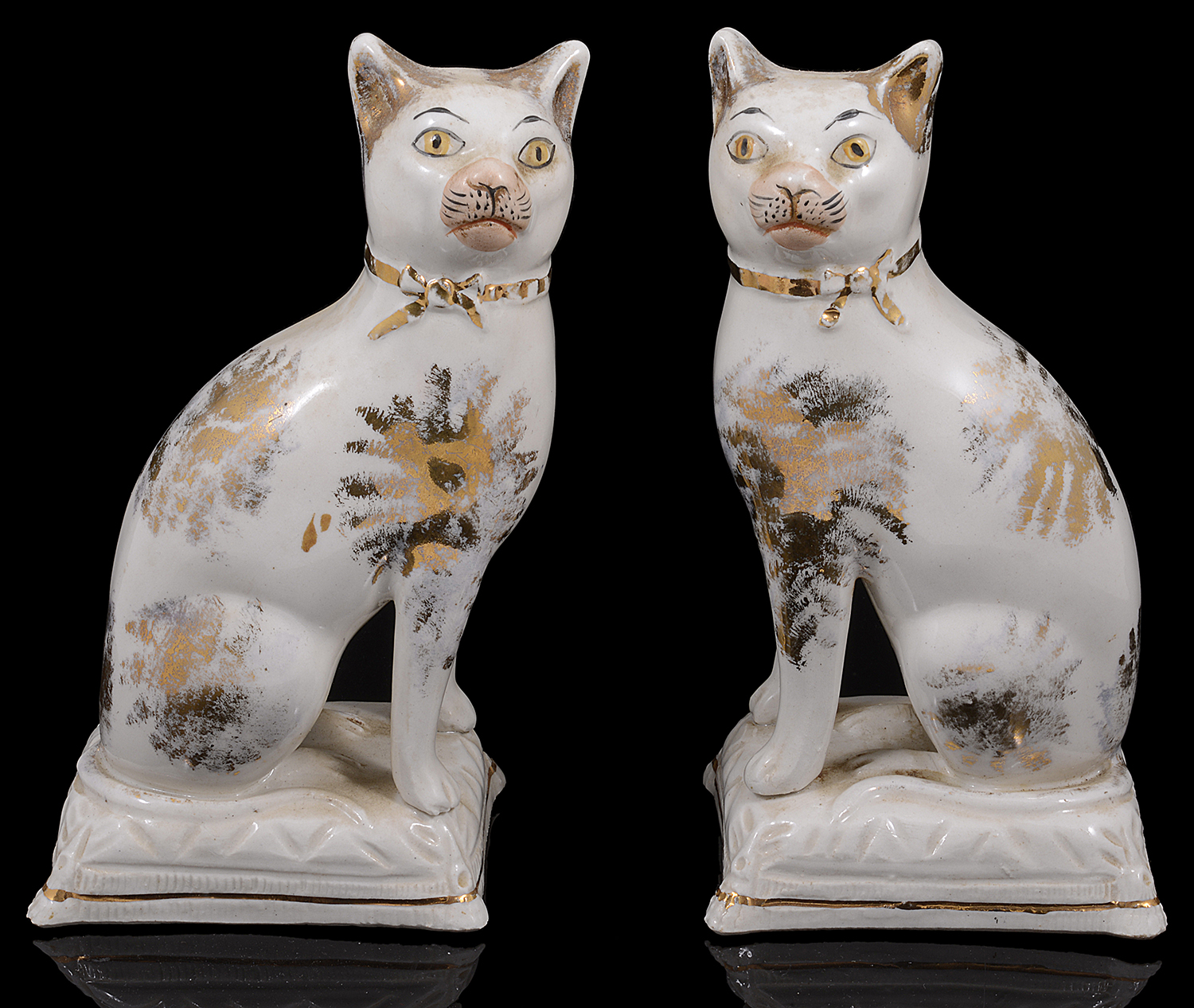 A pair of early 19th century Staffordshire pottery cats