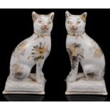 A pair of early 19th century Staffordshire pottery cats