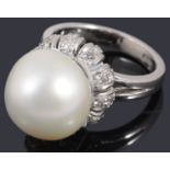 A white gold single stone cultured pearl and diamond ring