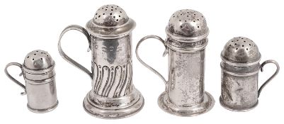 Four Victorian and later silver pepper dredgers in the form of kitchen pepper pots