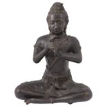 An Indian patinated bronze figure of a seated Hindu deity