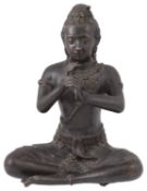 An Indian patinated bronze figure of a seated Hindu deity