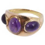 A gold three stone amethyst cabochon ring in the style of Lalaounis