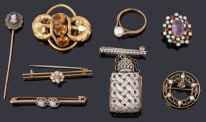 A collection of brooches including an Edwardian gold aquamarine and seed pearl wreath brooch