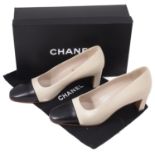 A pair of Chanel two tone leather court heel shoes