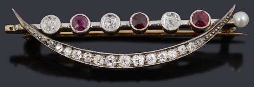 A delicate Edwardian ruby and diamond crescent brooch