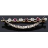 A delicate Edwardian ruby and diamond crescent brooch