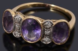 An unusual gold amethyst and diamond three stone ring